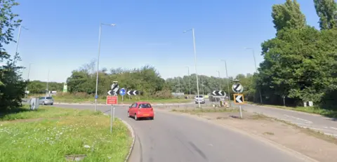 Cars on a roundabout.
