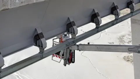 Getty Images Worker on crossing