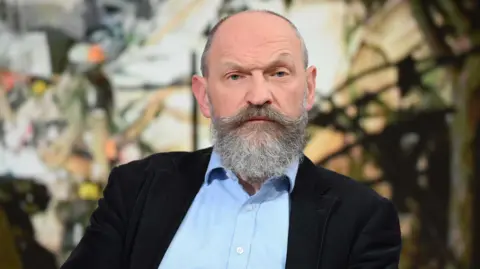 Chris O'Shea, chief executive of Centrica which owns British Gas, faces the camera wearing a dark suit jacket and light blue shirt