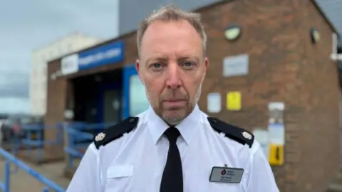 BBC/Charlie Rose A policeman in uniform with short fair hair and stubble. 
