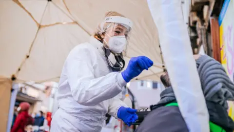 Getty Images Lisa Federle conducting a Covid test