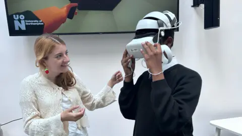 A woman guides a child in using a VR headset.