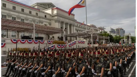 ELOISA LOPEZ Military officers march during a parade rehearsal, a day before the inauguration of president-elect Ferdinand "Bongbong" Marcos Jr., outside the National Museum in Manila, Philippines, June 29,