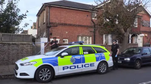 Eddie Mitchell Police outside the scene of the death