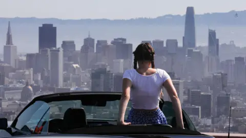 Lilou Guerra, 16, takes in the view of San Francisco during a heatwave on 3 July, 2024