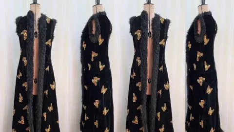 Cotswold Auction Company A collage of four pictures of the velvel black coat with butterfly embroiding on a manequin. 