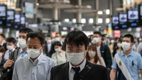 Getty Images Commuters return to work in Tokyo