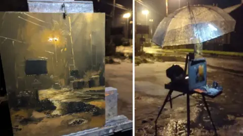 Rob Pointon Two images. Left, an oil painting of a snowy and rainy railway crossing lit by the street lamps. Right, the oil painting is sat on an easel beneath a clear umbrella illuminated by a battery powered light.