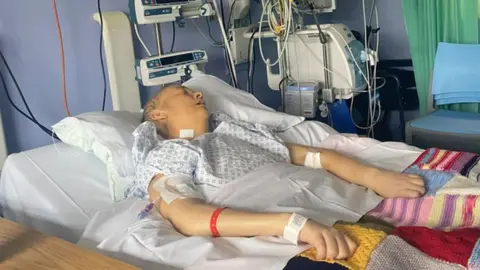 Handout Claire Boyd, who is unconscious, shown in a hospital bed. She is attached to lots of different machines.