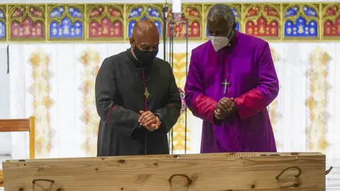 The Dean of St George's Cathedral Michael Weeder (L) and Archbishop of Cape Town Thabo Makgoba (R) stand near the coffin of late Archbishop Emeritus Desmond Tutu in St George's Cathedral in Cape Town, South Africa, 30 December 2021