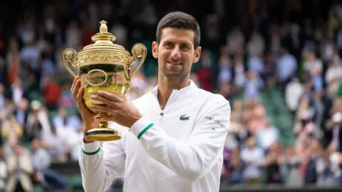 Getty Images Novak Djokovic lifts cup at Wimbledon