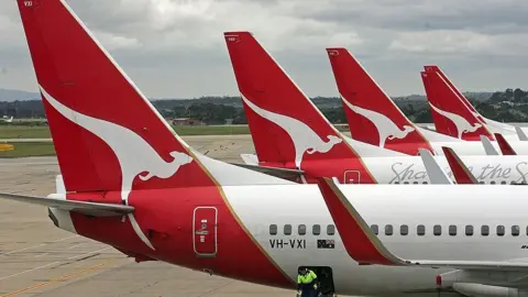 Getty Images A mixture of Qantas aircraft parked on one of the three runways in Sydney, Australia.