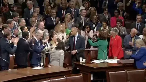 Hakeem Jeffries is surrounded by his peers.