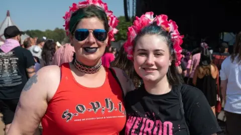 Katja Ogrin Two festivalgoers with pink headbands at the festival