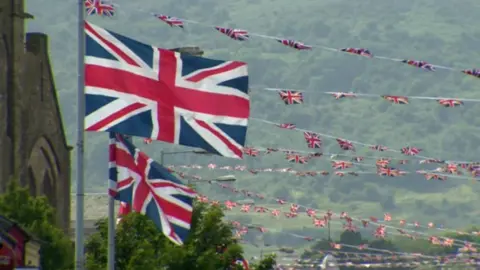 Union flags flying from lampposts in Belfast