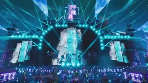 Marshmello/Fortnite A virtual stage with lights, pyrotechnics, and holograms. Marshmello - a DJ with a large marshmello on his head - is playing the stage.