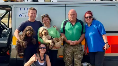 Contributed Mr and Mrs Burgess pictured with some of the search teams after Dora was successfully located