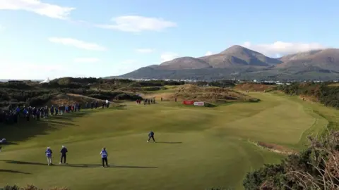 PA Media Golfers on the green at Royal County Down Golf Club. The Mourne Mountains can be seen in the distance.