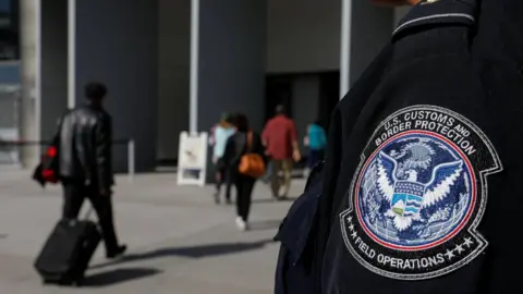 Reuters A US Customs and Border Protection agent at the San Ysidro crossing point