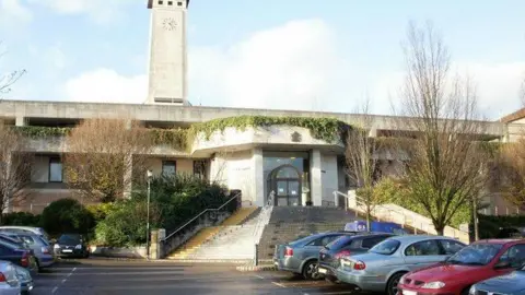 Jaggery/Geograph Newport Crown Court with car park visible and steps up to court behind and concrete facade of court building with clock tower