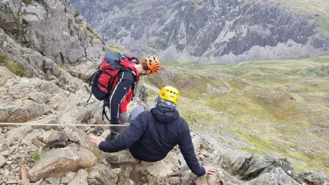 Llanberis Mountain Rescue Team Two men winching themselves down a gorge in Snowdonia