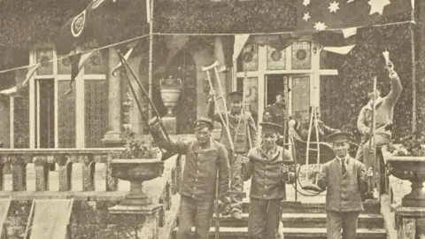 Massey-Harris Company/Library and Archives Canada A black and white image showing injured Canadian soldiers holding their crutches in the air