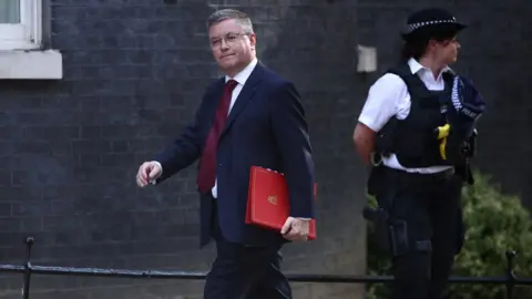 Reuters Welsh Secretary Robert Buckland pictured walking along Downing Street