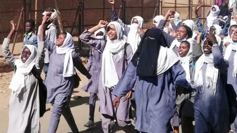 Getty Images Schoolgirls protesting in Sudan - January 2019