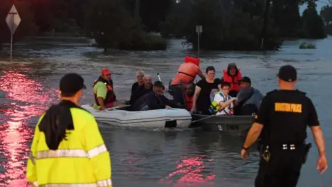 AFP Victims are rescued by boat in Houston