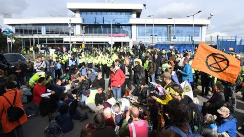 EPA Extinction Rebellion protesters block the entrance London City Airport in London on 10 October