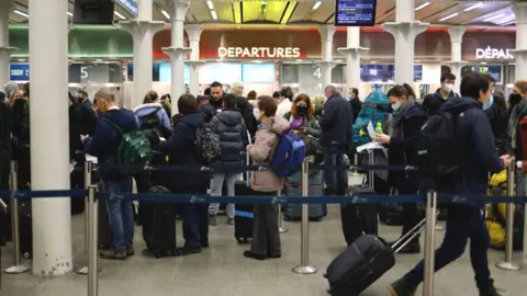 Getty Images Passengers at St Pancras station, queuing for the Eurostar