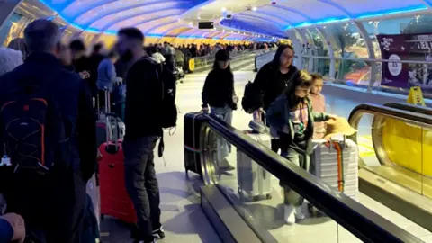 Martin Daniels Queues at the airport