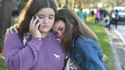 Getty Images Two students hug each other after the shooting