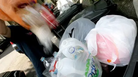 PA Media Waste being emptied into a wheelie bin