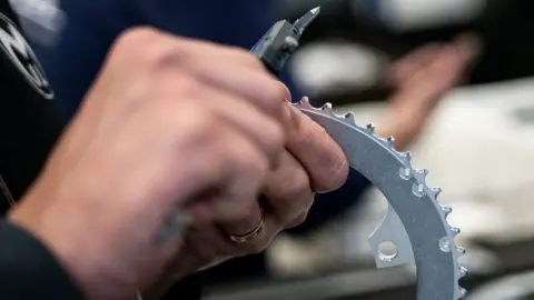 Miranda A bike front gear ring being tested by a Miranda employee