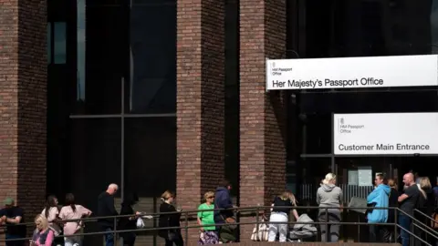 Joe Giddens/PA Queue outside passport office in Peterborough taken earlier in May