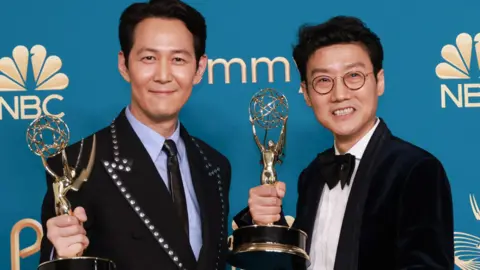 Reuters Squid Game actor Lee Jung-jae (left) and creator Hwang Dong-hyuk with their Emmy awards