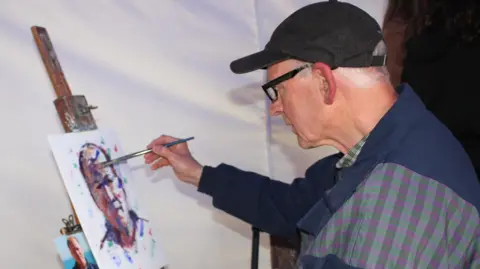 Michael Stepniak A man painting a picture 