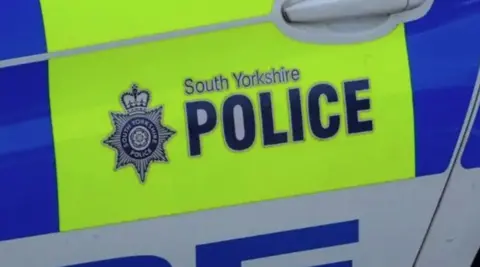 Signage for South Yorkshire on the side of a police car