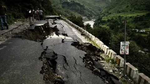 Tarin Ramola Ramagar Road that is in Dharm from the Dharali visible after the rain falls and flooded the lightning. 