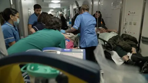 Patient victim is being seized through a busy corridor