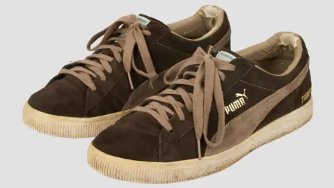 Press Association A pair of Puma trainers. They are brown and look worn.