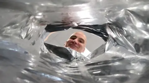 BBC Development chef Patrick Clifford looks into a bag of crisps