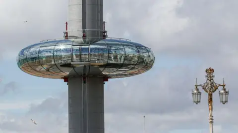 Getty Images A circular glass viewing pod on a long grey circular structure.