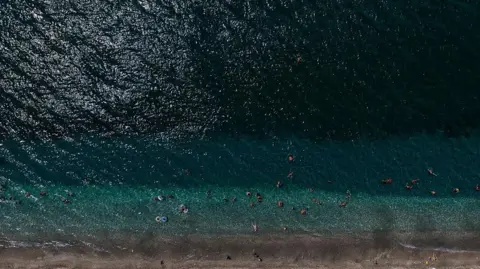 Aerial view of strip of beach in Greece and ocean