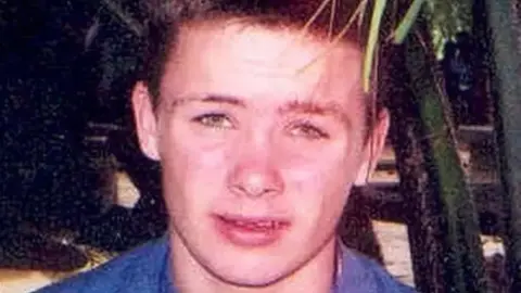 Merseyside Police A teenage boy with shirt brown hair and a blue t-shirt looks into the camera