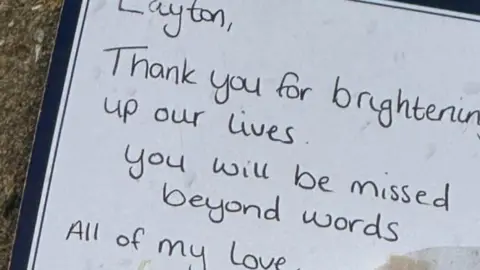 A handwritten note saying "thank you for brightening up our lives, you will be missed beyond words, all my love."