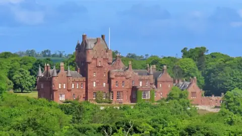 Anne Burgess Ayton Castle - an imposing sandstone building with various turrets surrounded by trees