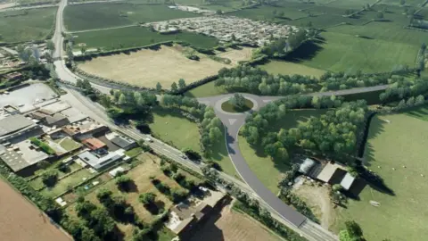 A 3D aerial projection of the Banwell bypass. There are many green fields and trees showing a rural setting. There are three grey road that join in a large island, taking traffic away from the main road.