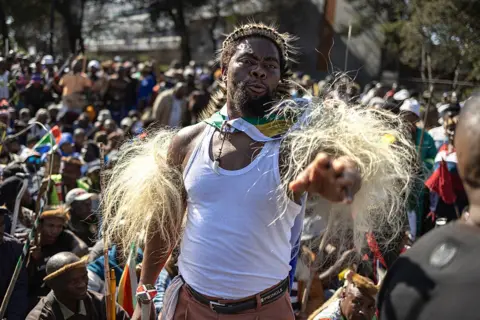 AFP via Getty Images Nkosikhona "Phakelumthakathi" Ndabandaba gestures during a march against undocumented migrants organised by March in March movement in Soweto on 29 June.